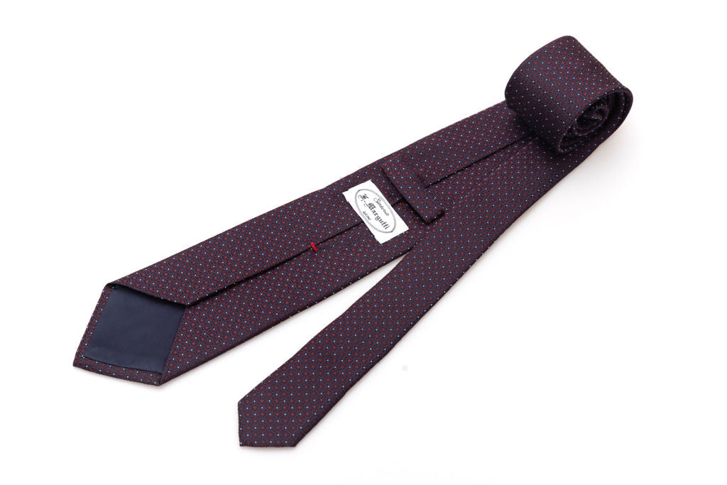 Blue tie with red geometrics in pure silk