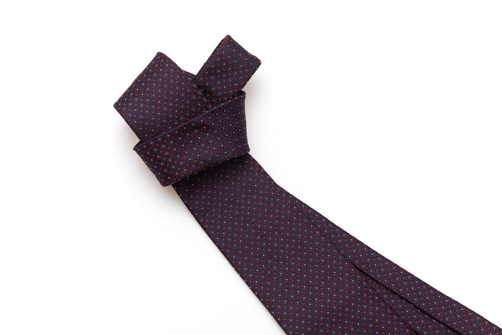 Blue tie with red geometrics in pure silk