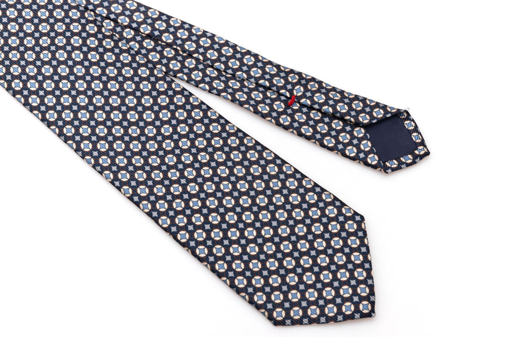 Cravatta blu con geometria bianca e celeste in pura seta