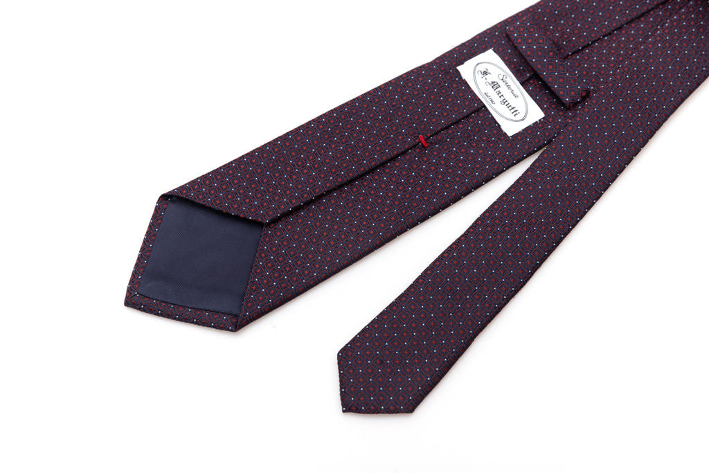 Blue tie with red geometrics in pure silk