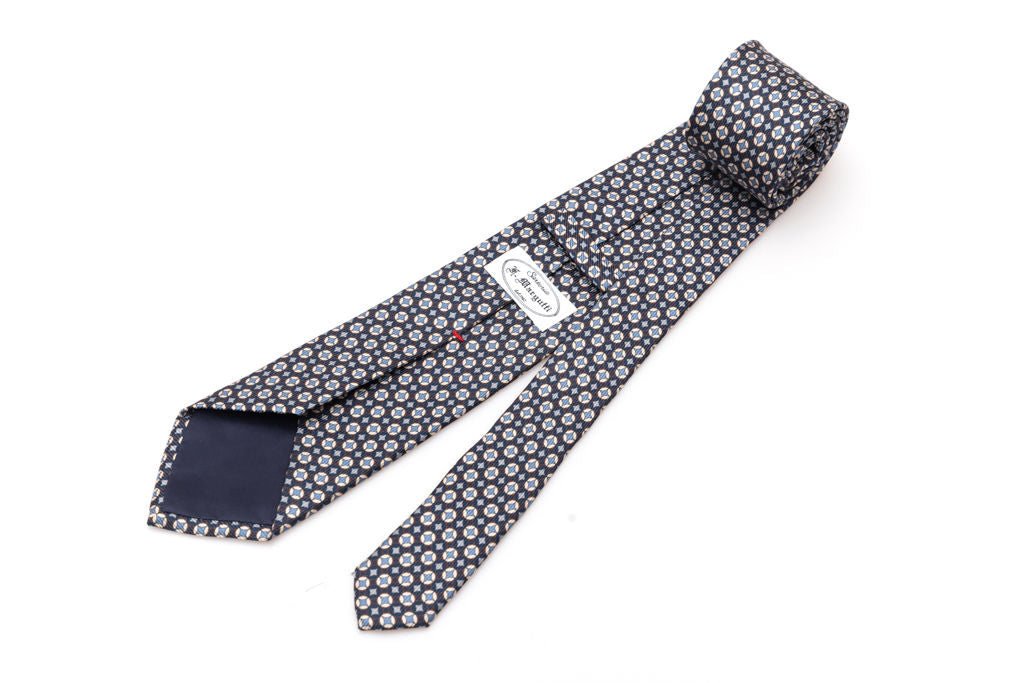 Cravatta blu con geometria bianca e celeste in pura seta